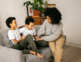 black mother with positive sons on couch